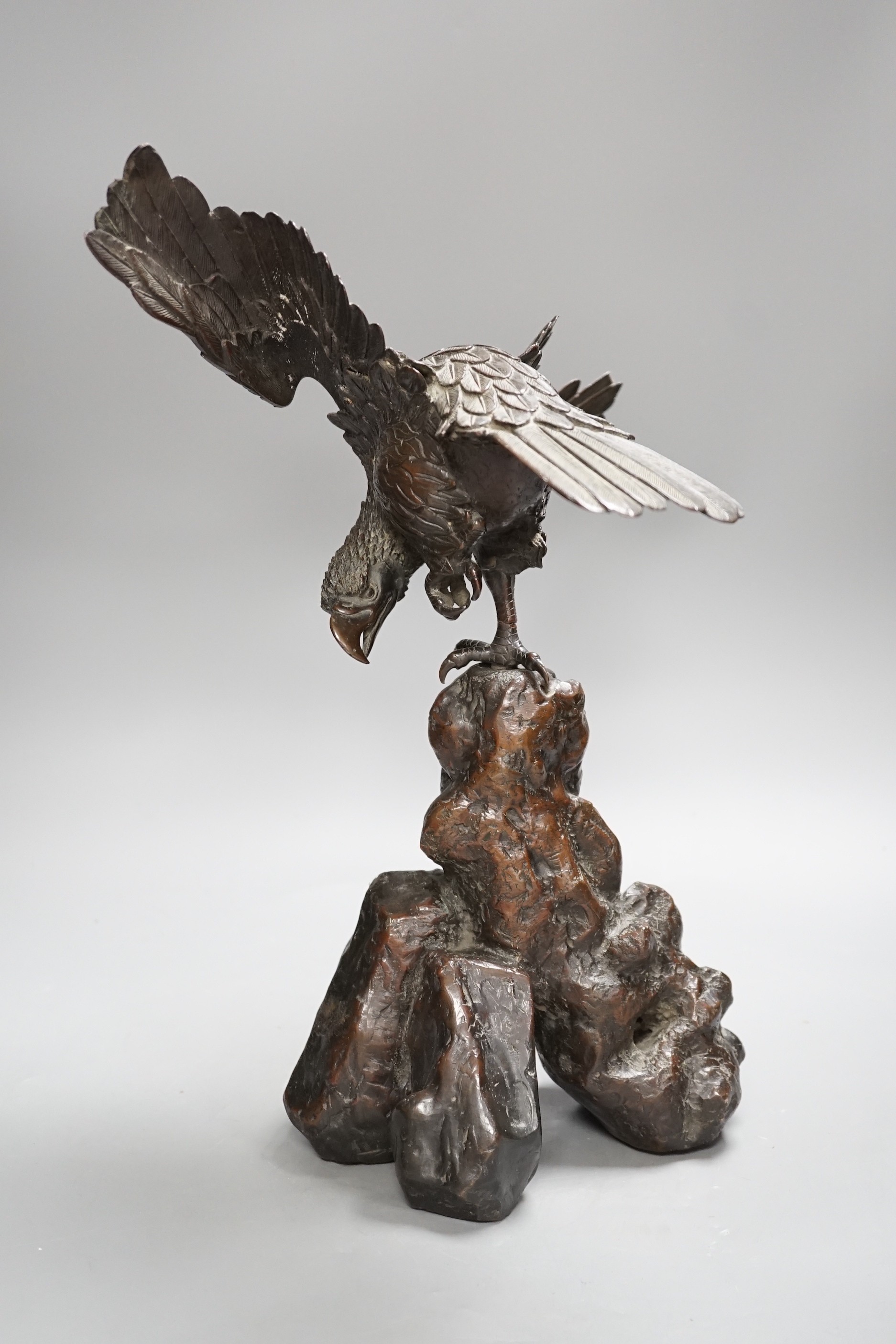 A Japanese bronze model of an eagle on a rock, Meiji period, 40cms high.